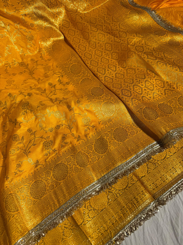 Bright yellow banarasi georgette silk saree with silver meena & lace work
