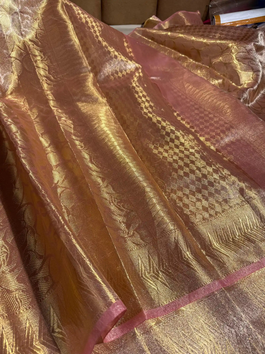 Gold and pink patterned fabric with a textured surface