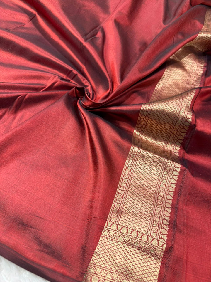 Dusty Maroon Pure Katan Silk saree with a gold zari work and border.