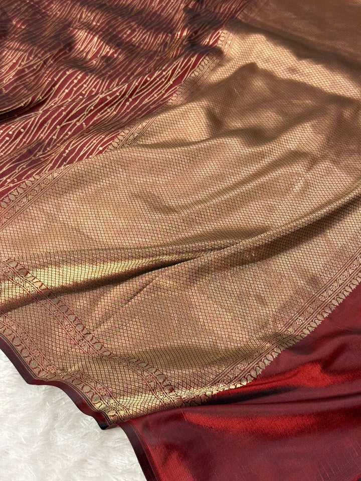 Close-up of a red and gold fabric with intricate patterns