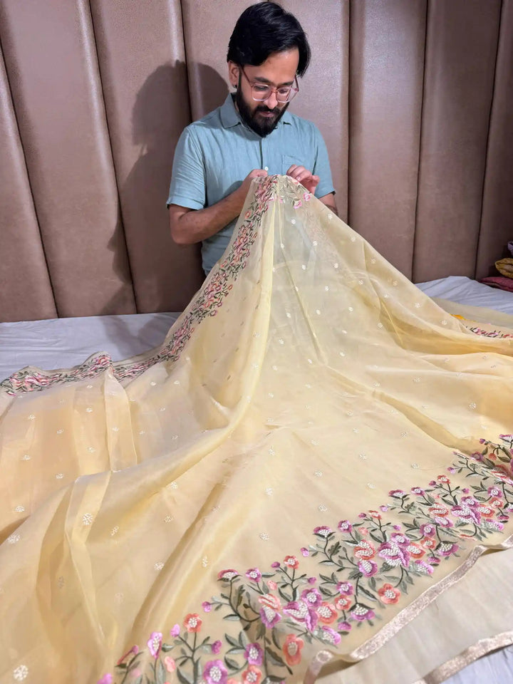 Light Yellow Banarasi organza silk with NoorTaar technique border and pallu work with premium tassels