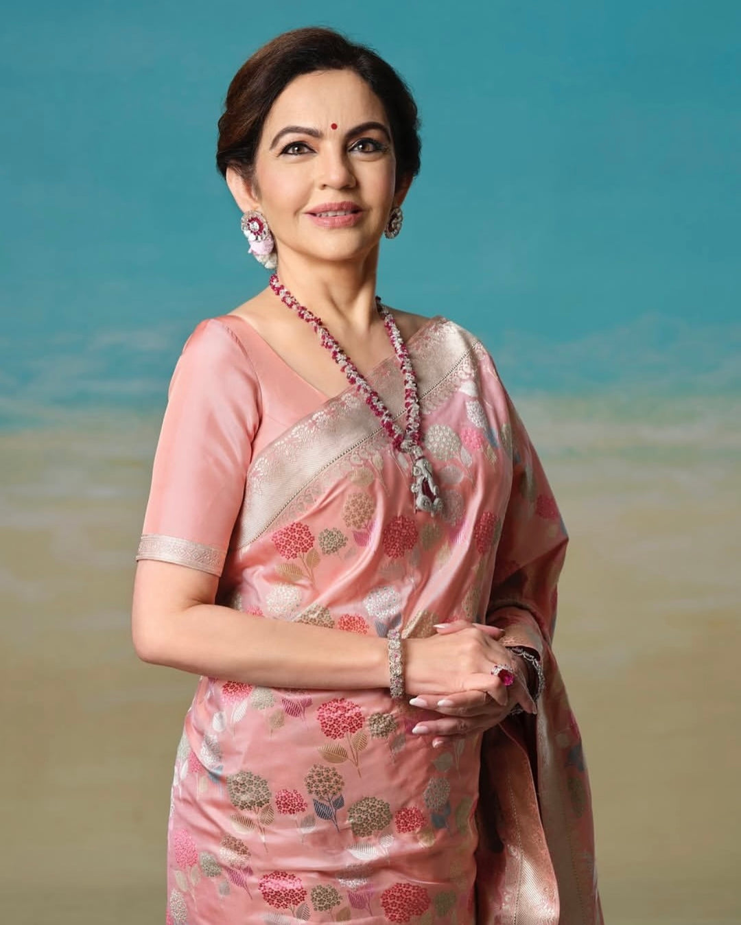  Nita Ambani Ma’am Inspired Peach Katan Silk Floral Embossed Meenakari Banarasi Saree
