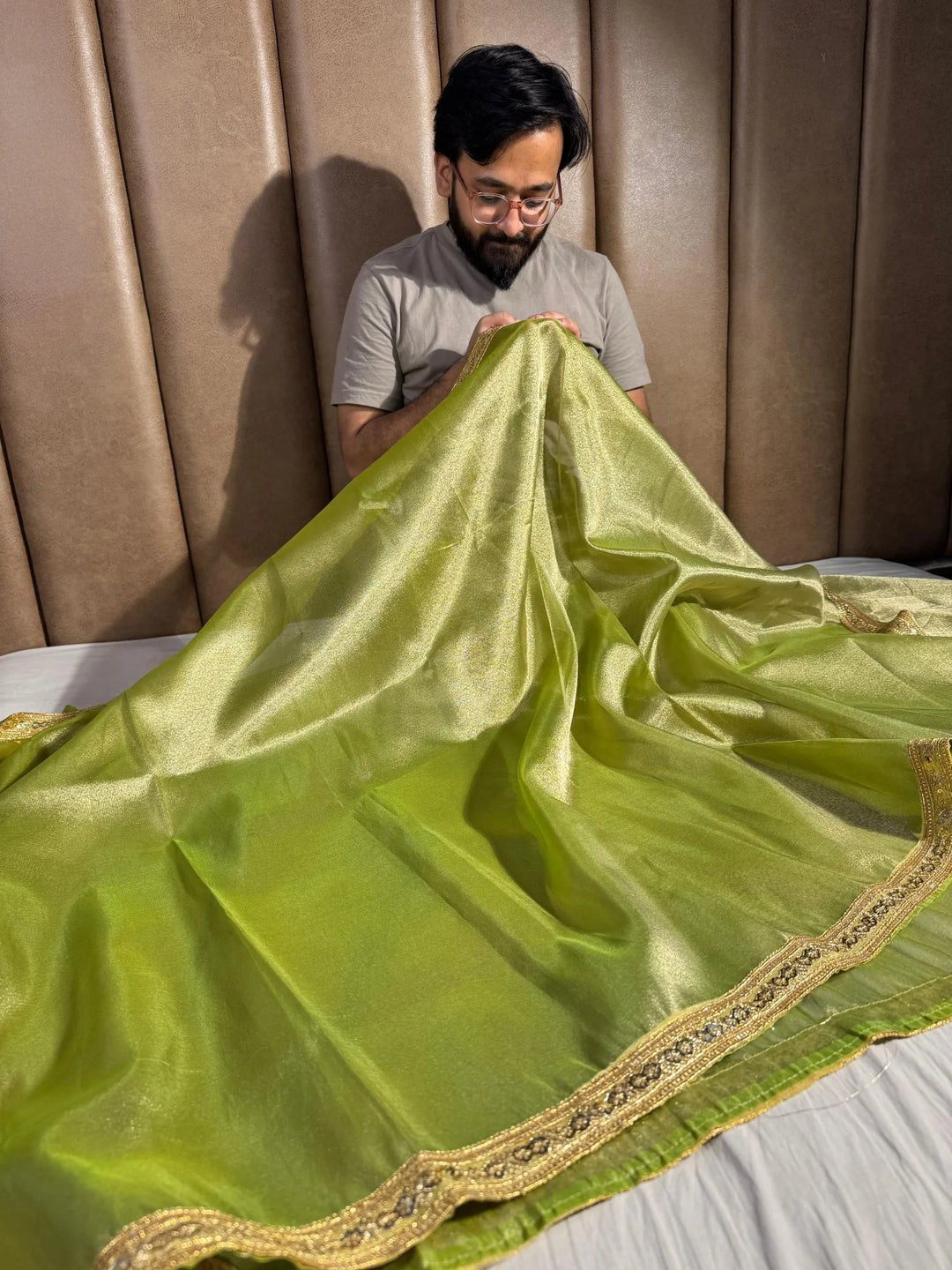 Premium green shade tissue silk saree with lacework