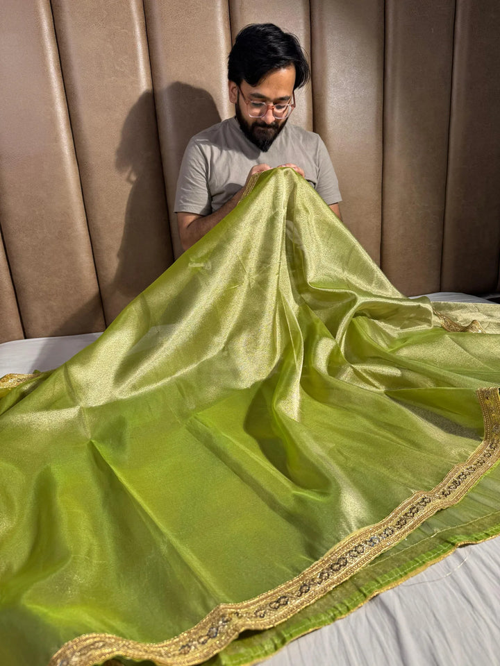 Premium green shade tissue silk saree with lacework