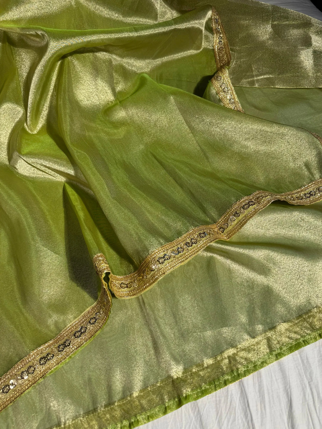 Premium green shade tissue silk saree with lacework