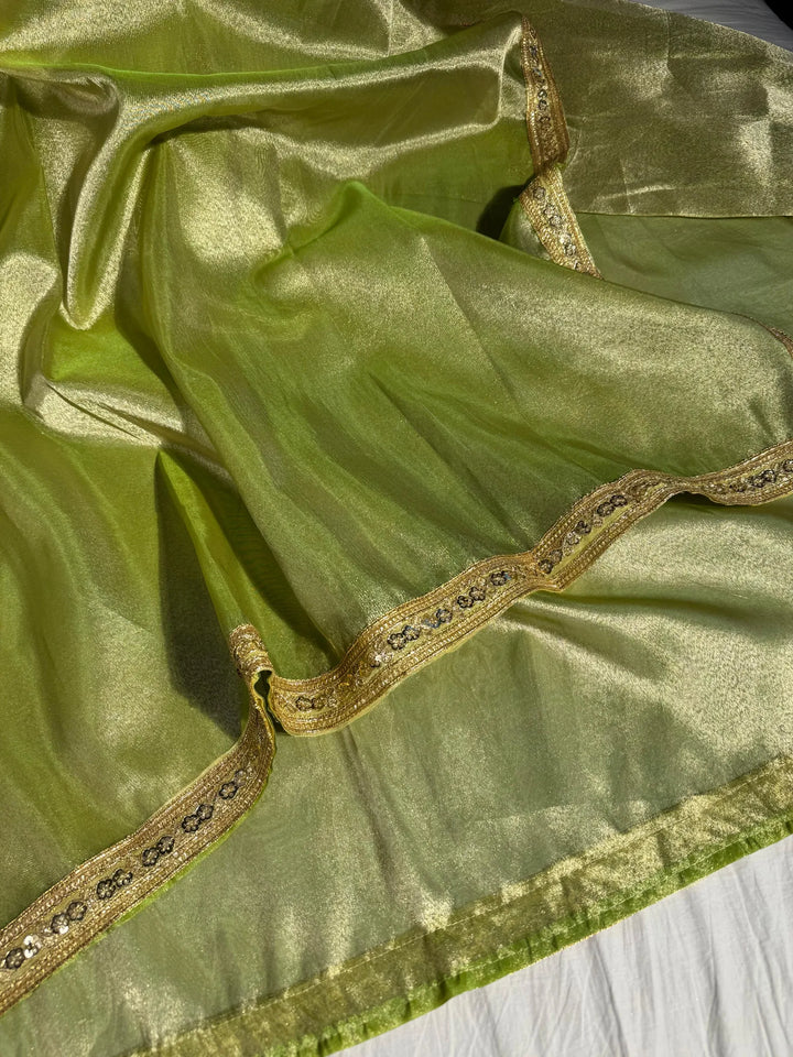 Premium green shade tissue silk saree with lacework