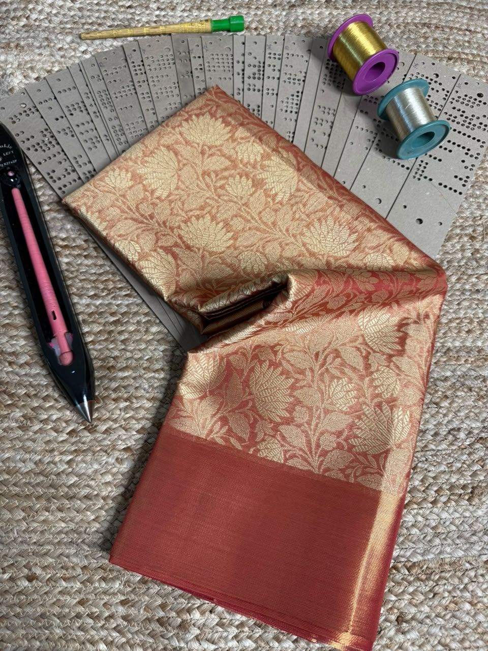 Dull red embossed Softsilk saree