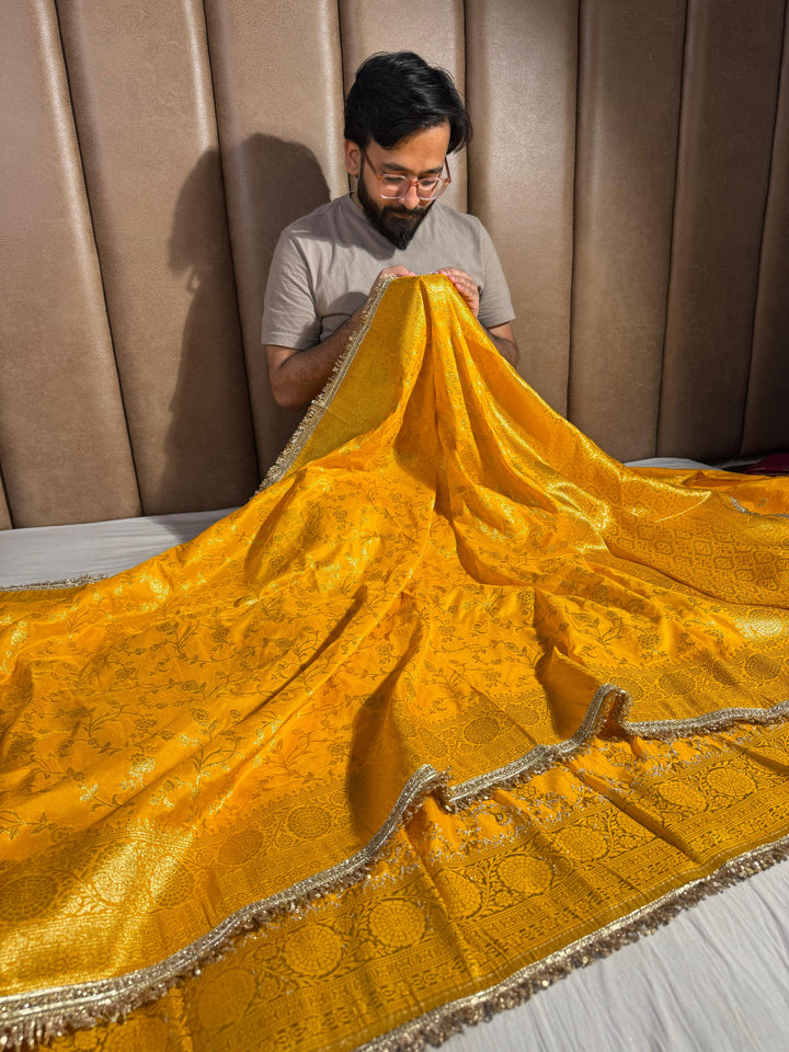 Bright yellow banarasi georgette silk saree with silver meena & lace work